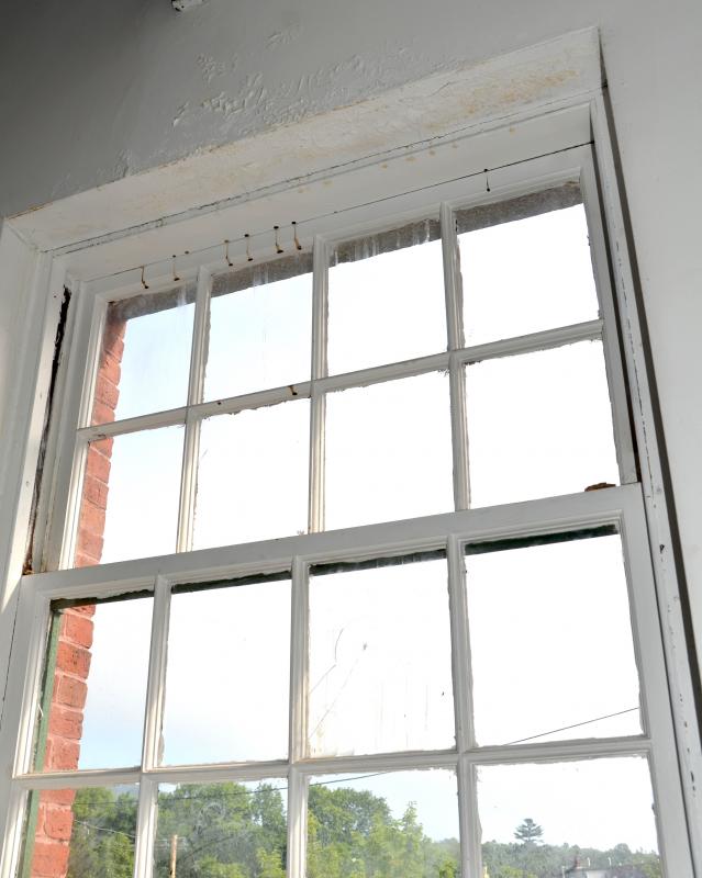 A window in disrepair in the back of the Camden Opera House.