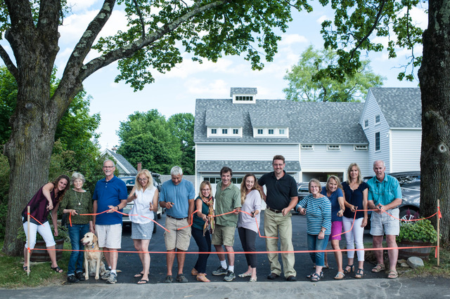 Those attending the ribbon cutting ceremony included Beth Gindel, Molly McKellar, “Annie of course!”, Sandy Cox, Lisa Decker Griffith, Steve Pixley, Sharyn Pohlman, Jeff Walsh, Natalie Hart, Justin Humes, Donee Wyke, Charlotte Horovitz, Abby Enggass and A. Flint Decker. (Photo courtesy New England Real Estate Company)