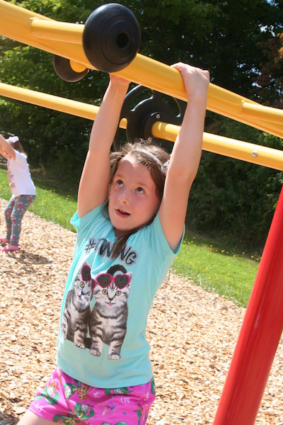 Alora Stewart hangs from the monkey bars. (Photo courtesy Thomaston Grammar School)