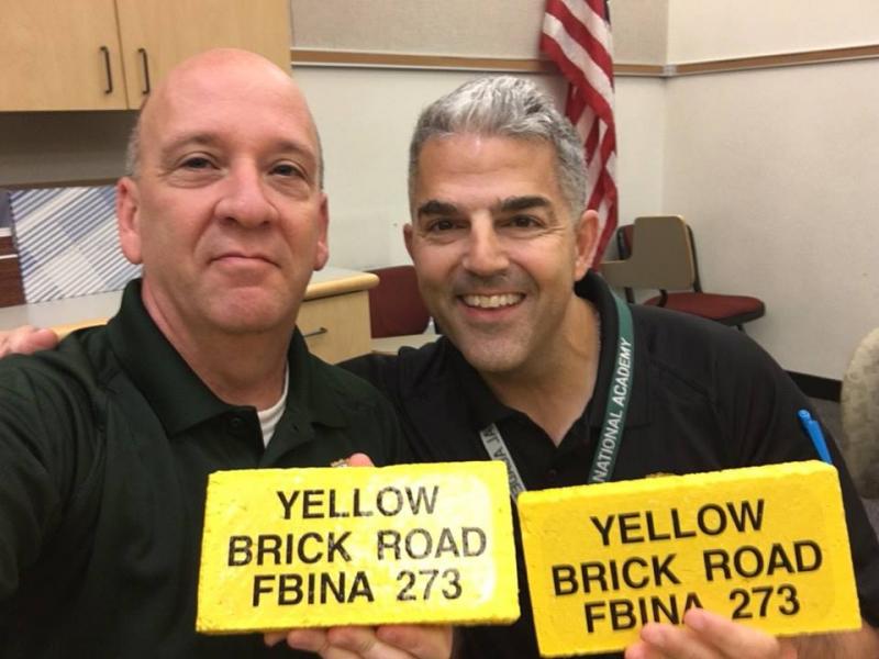 Chief Deputy Jason Trundy (left) poses with the yellow brick he earned after completing the FBI National Academy’s Yellow Brick Road challenge. (photo courtesy of Chief Deputy Trundy)