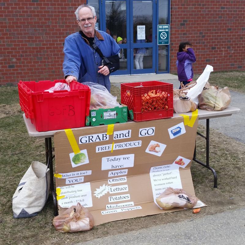 Volunteer Alex Gardiner attends to one of the tables during the April Farmer's Market. From April to October of this year, they have grown from using two tables to using 10 tables. (Photo courtesy Brenda Thomas)