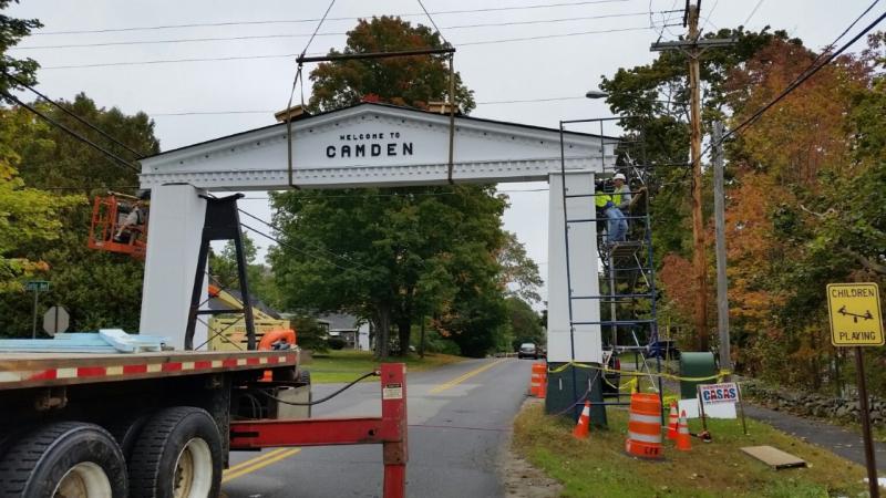 The iconic Camden-Rockport arch, removed Aug. 23 after a delivery truck crashed into the left pillar, was lowered back in place Oct. 4 by Rockport Steel. (Photo by Sarah Shepherd)