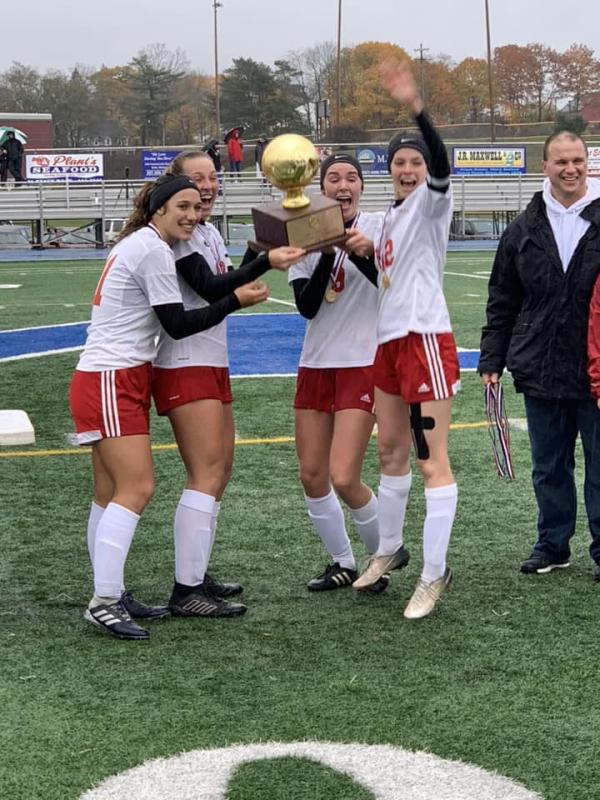 Camden Hills celebrating its third consecutive state championship. (Courtesy Steve Alex)