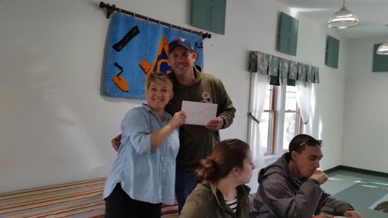 Andrew Lowe cheerfully accepts his raffle prize. (Photo by Sarah Shepherd)