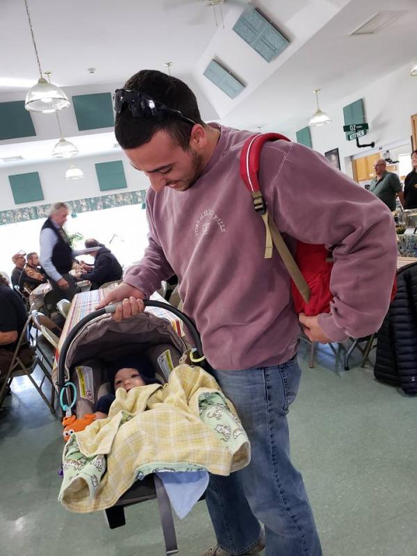 Rockport Police Officer Tony Del Vecchio and his son, Frances, who later woke up from his nap to enjoy the festivities and meet some first responders. (Photo by Maggie Timmermann)