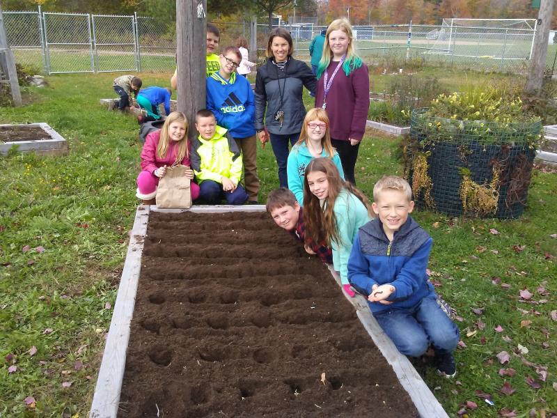 TGS 5th graders and teacher, Lynn Snow, planted seed garlic earlier this fall. (Photo courtesy of Thomaston Grammar School)