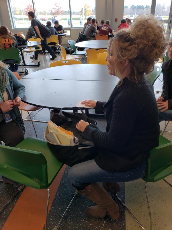 Wenz discussing the purpose of their visit with Tina Fabian to wipe clean the debts of unpaid lunch accounts for all the kids.