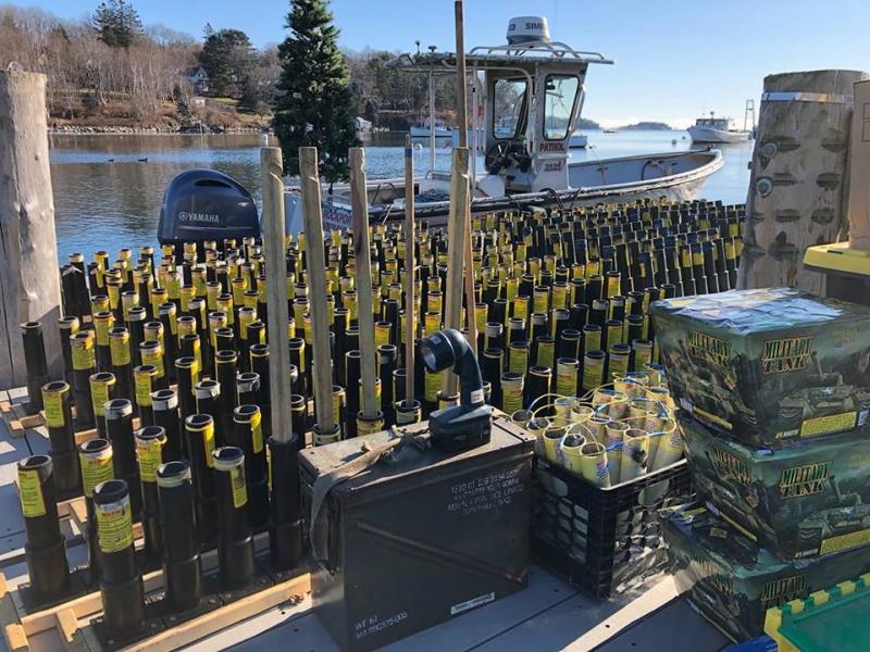 Hundreds of fireworks prepared to be loaded onto a barge in Rockport Harbor on Dec. 8. (Photo source: Facebook, “Holiday on the Harbor”)