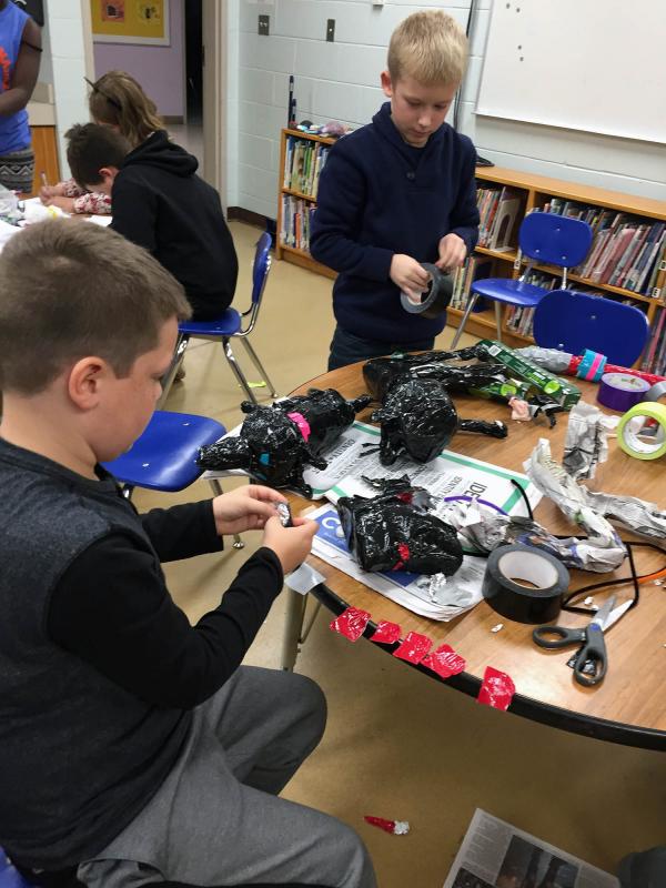 Youth artists Brayden Lawrence (left) and Jackson Russomano (right) are using different techniques to make duct tape animal sculptures. (Photos courtesy of Arts in Action)