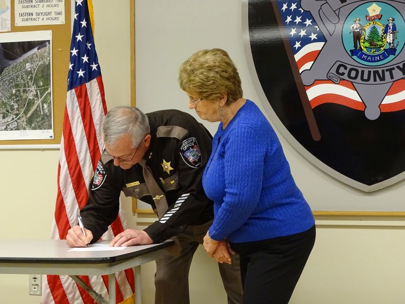 Trafton signs the oath he just took. (photo by Erica Thoms)