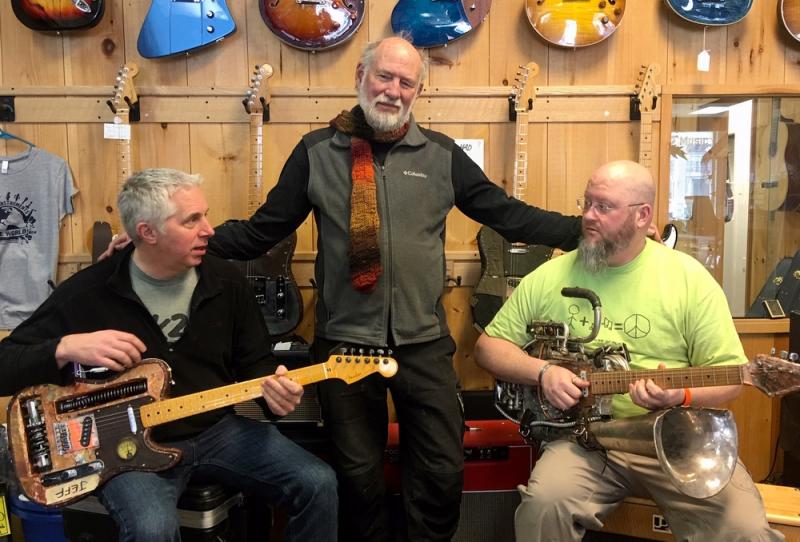 Mac Economy, Jack Churchill and Harvey Curtis with the guitars on display at K2 Music. (Photos by Chris Wolf)