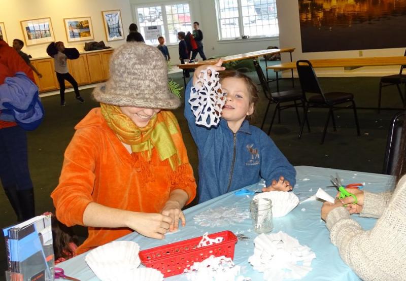 Waterfall Arts provided a craft station for kids (and adults) to create paper snowflakes. (photo by Erica Thoms)