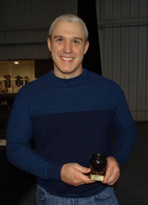 Colson poses with last year’s trophy. (photo by Erica Thoms)