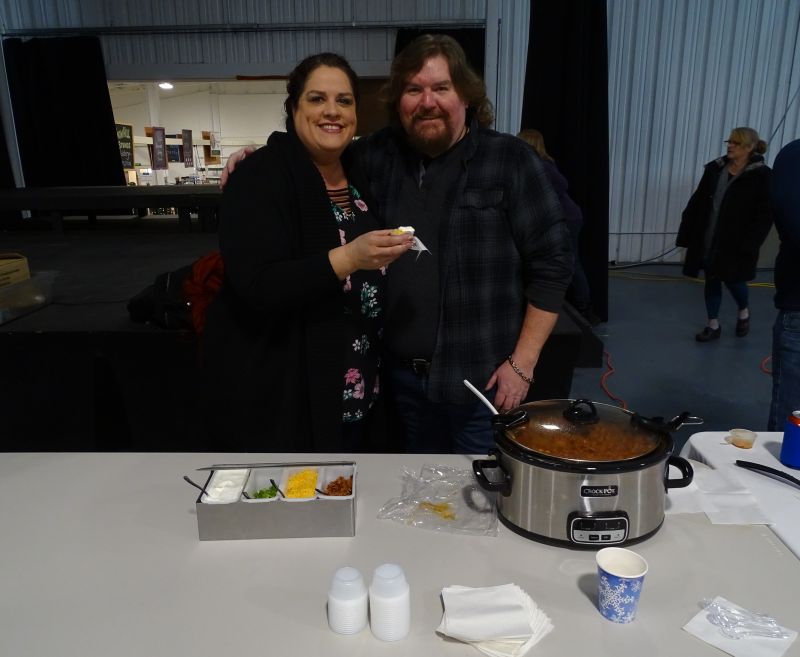 Emily Berry (left) and Bob Waldron (right) said their chili is made with two kinds of pork, including bacon, as well as chicken, steak, and nine varieties of peppers. “We’re hoping to unseat the champs,” Waldron said, gesturing toward cook-off neighbor Jarod Colson. Waldron said the two became friends during last year’s competition. (photo by Erica Thoms)
