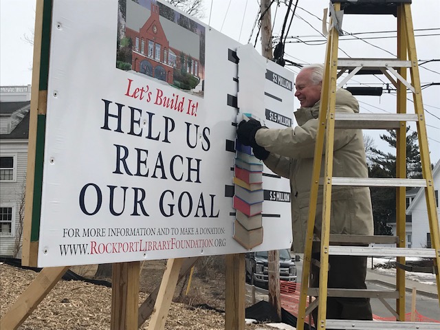 Rockport Library Foundation Vice President John Viehman peels off another milestone for the library capital campaign. With a recent $150,000 donation from the Rockport Library Committee, the Foundation has collected $1.45 million toward its $2 million goal. (Photo courtesy Rockport Library Foundation)
