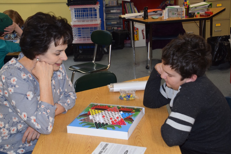 Grade 3 teacher, Rose Richter and Owen deLorimier play Chinese Checkers as during a stay-cation trip around the world. (Photo courtesy Thomaston Grammar School)