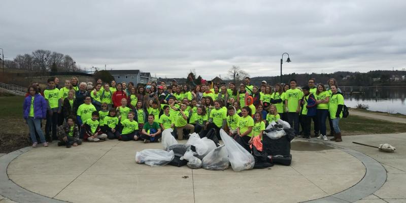 The Troy Howard Middle School’s sixth-grade team poses in front of the garbage they collected from Belfast’s streets May 2. (photo by Erica Thoms)