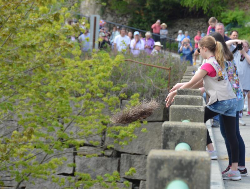 Tossing a wreath off the Goose River Bridge for those lost at sea. (Photo by Lynda Clancy)