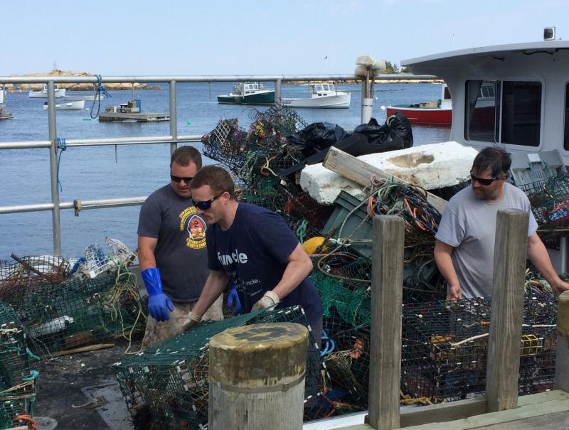 Loading Matinicus lobsterman Jarod Bray’s boat “Volition.” Left to right: lobsterman Derek Webber, Jarod Bray, lobsterman Sam Rogers. (Photo courtesy Eva Murray)