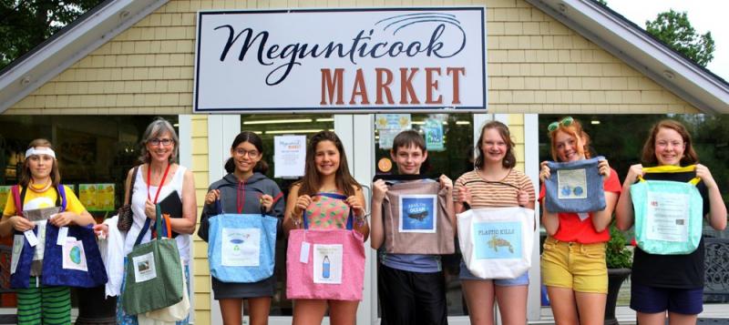 Seventh-grade students from Camden-Rockport Middle School line up in front of Megunticook Market to show off their work. (Photo by Ellen Curtis)