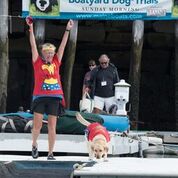 Humor is a key ingredient at the trials, where the watchword is fun. Here, World Champ Zola and her wonder person celebrate their victory. (Photo by Bell’s Furry Friends Pet Photography)