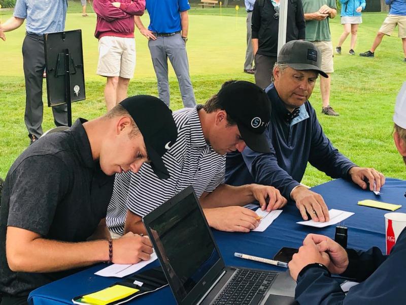 Cole Anderson at the scoring tent with his final round partners Reese McFarlane and Jason Gall.