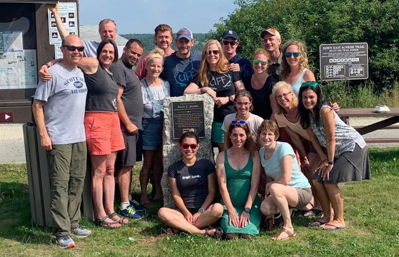 Standing at the plaque in Machias (across from Helen’s Restaurant) honoring the woman whose Downeast Sunrise Trail Coalition has brought annual activity and economy to an under-recognized area. (Photo courtesy Trail Runners of Midcoast Maine)