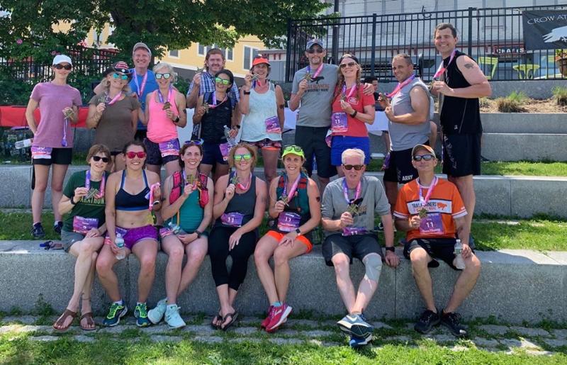 Two Midcoast teams, plus a few more runners from the Midcoast, pose for a photo at the finish line. (Photo courtesy Trail Runners of Midcoast Maine)
