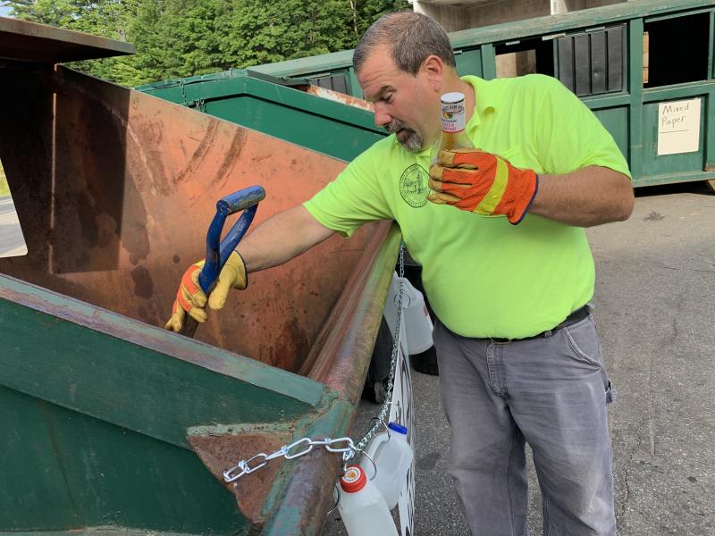 Saturday morning, July 20 at Wiscasset Transfer Station, Superintendent Ron Lear pulls a wrongly placed bottle from the bin for #2 plastics. SUSAN JOHNS/Wiscasset Newspaper