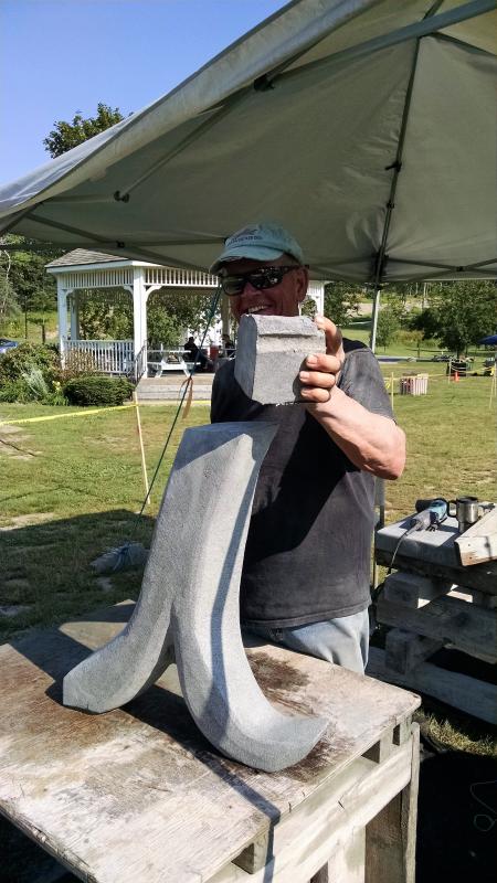 Dick Alden (East Boothbay) and his piece inspired by a cursive I. He will be assisted by Guild president Norman Cassas at some point to engrave lettering into the granite itself. Margaret Hoffman photo