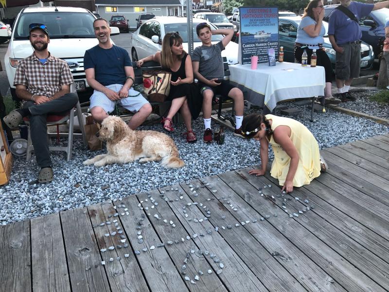 Creative work on the dock prior to fireworks over Camden Harbor. (Photo by Lynda Clancy)