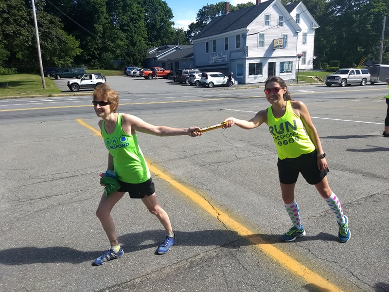 Theresa Withee receives the baton from Jala Tooley.