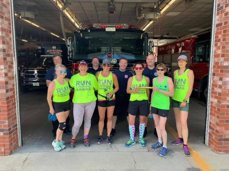 Stage 14 transition point at the Rockland Fire Station. Front row, L-R: Mary Smith, Doug Johnstone, Beth Wilkas Feraco, Jala Tooley, Theresa Withee, and Frances Killea. Back row: Asst. Fire Chief Adam Miceli, Firefighter Rusty Barnard, Firefighter Max Negley, and Lt. Patrick Lowe. (Photo courtesy Run2Respond)