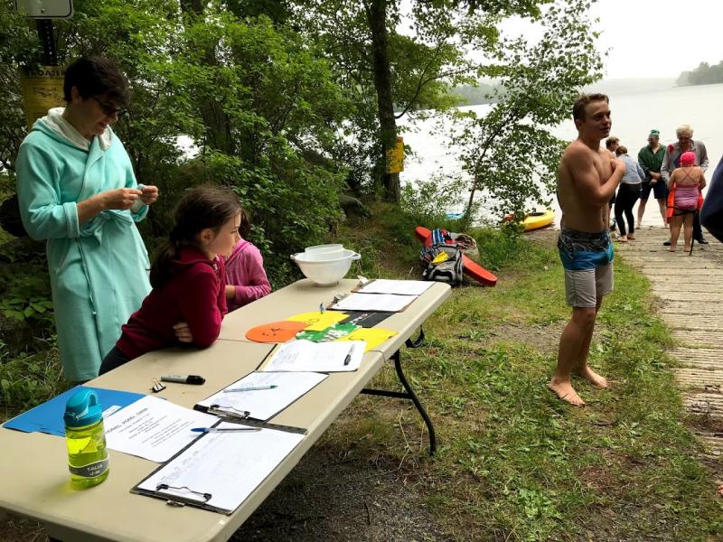 Alison Jones, Hazel Eckelman, and Talia Jones-McKeon at the check in table. Vernon Smith preparing to spot. (Photo by Judith Jones)