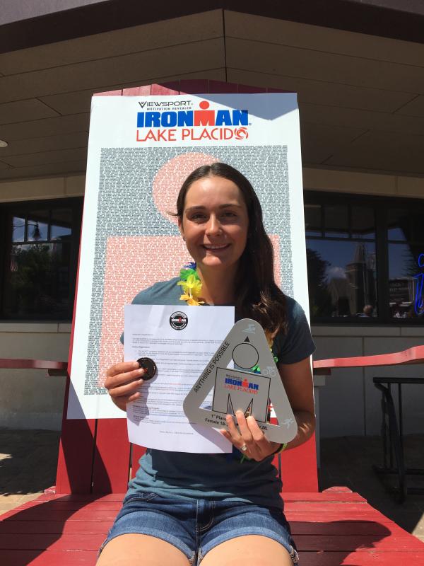 Katie Clayton with her awards after finishing first in her division at the Ironman Lake Placid triathlon. (Courtesy Bruce Clayton)