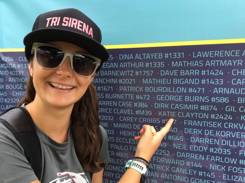 A smiling Katie Clayton points to her name on the list of participants at the Ironman World Championship in Hawaii. (Courtesy Bruce Clayton)