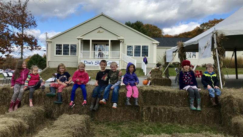Children perch on hay bales during the October 26 Harvest Fest. (Photo courtesy Dow Furniture)