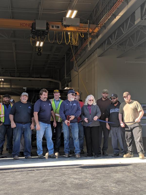 Ribbon cutting in front of the new public works facility: Jody Seekins Jr., Jay Hassepelis, Kip Faulkner, Scott Sawyer, Bob Richards, Alan Armstrong, Mary Mortier, Brian Richter, Steve Warman, Brandon Peasley. (Photo courtesy Ledgewood Construction)