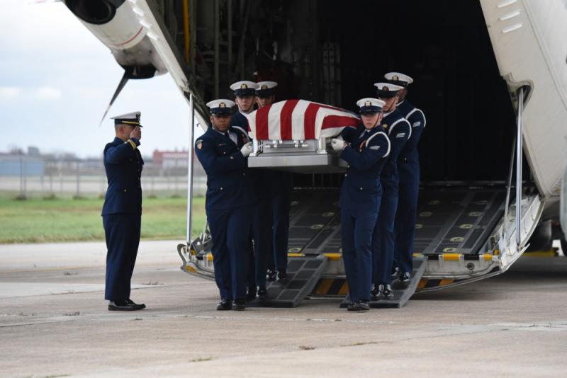 Ceremonial Honor Guard transfers the remains of Lt. Thomas Crotty, a USCG WWII POW, from a Coast Guard C-130 fixed-wing aircraft to a hearse. (U.S. Coast Guard photo by Petty Officer 3rd Class Brian McCrum)