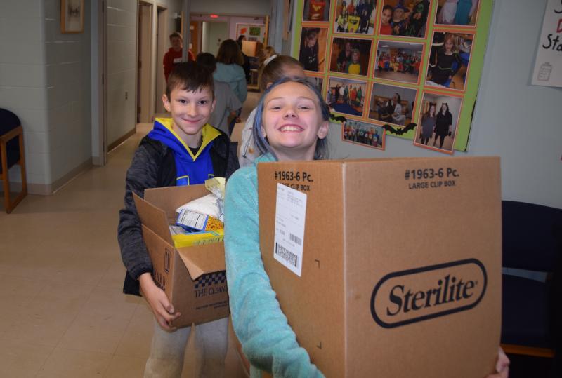 Maddox Lowell and Addison Lincoln help load the food donations. (Photo courtesy Thomaston Grammar School)