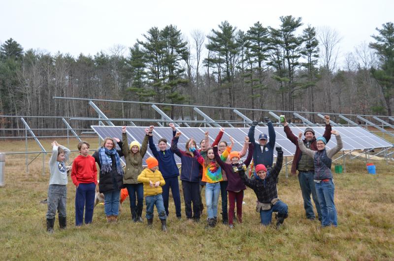 Sweetland School students, Hope Solar Committee representatives and ReVision Energy solar installation experts gather in the Hope field, Nov. 25, to celebrate a new solar array. (Photo by Lynda Clancy)