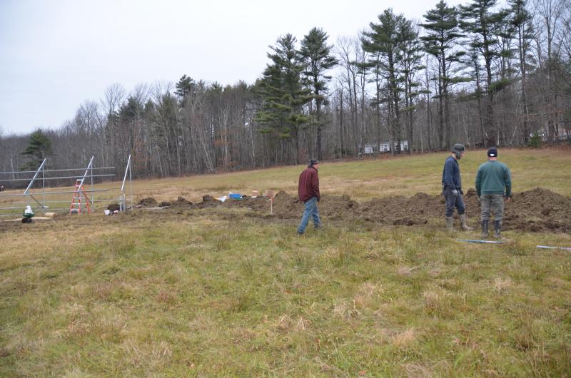 Digging the power line from the solar array to a new CMP pole on Route 105.