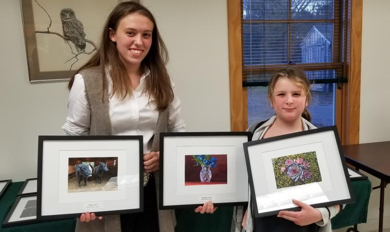 Aldermere Achievers 4-H members, Elizabeth Eaton and Isabelle Baker, hold their photos from the Knox-Lincoln 4-H Photography Contest. (Photo by Heidi Baker)