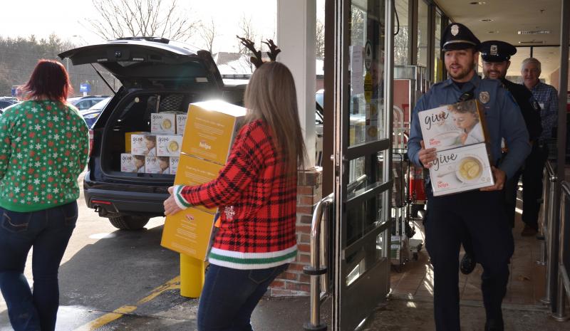 Filling the cruiser, box by box — 590 total — and many trips back and forth to the Camden Area Food Pantry. Mariah Singer and Candie Martin, Hannaford employees; Rockport Police Officer Tony Del Vecchio; Camden Police Officer Mark Bennett; and Camden Hannaford Store Manager Bob Josselyn. (Photo by Lynda Clancy)