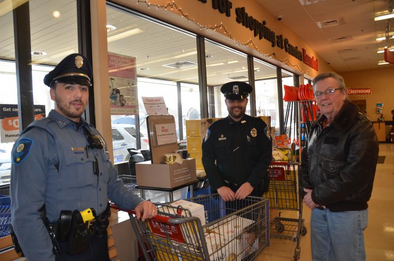 Rockport Police Officer Tony Del Vecchio, Camden Police Officer Mark Bennett, and Camden Area Food Pantry volunteer Bill Komulainen. (Photo by Lynda Clancy)
