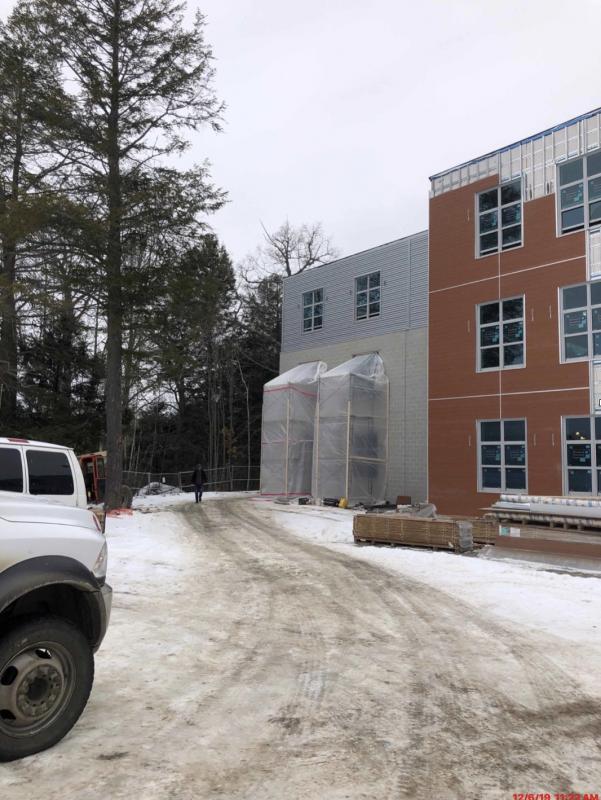 This is a view of the south side of the academic wing. The Nishiha siding in red is being installed in several bump out areas. (Photo courtesy Steve Claffie)