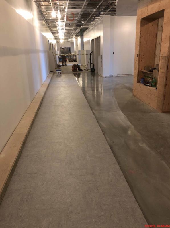 This is a picture of the ground floor with part the hallway flooring installed. It is a marmoleum product. Classrooms will have carpet tiles. (Photo courtesy Steve Claffie)