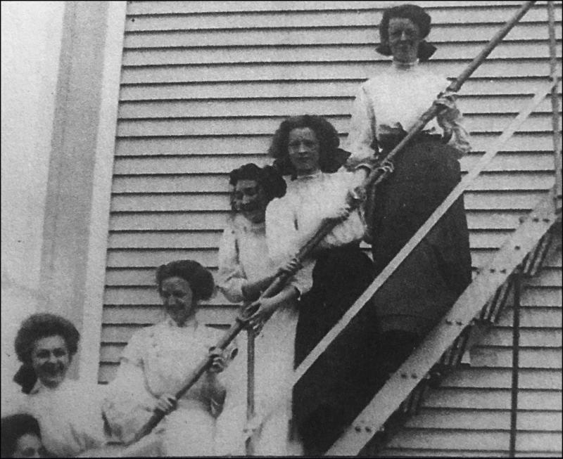 Five seniors pose on the fire escape at Camden High School in 1909, the year of their graduation. From left are Mary Pendleton, Stella Derry, Marion Payson, Margaret Cripps, Edna St. Vincent Millay, and Corinne Sawyer. (Collections of Camden Public Library)