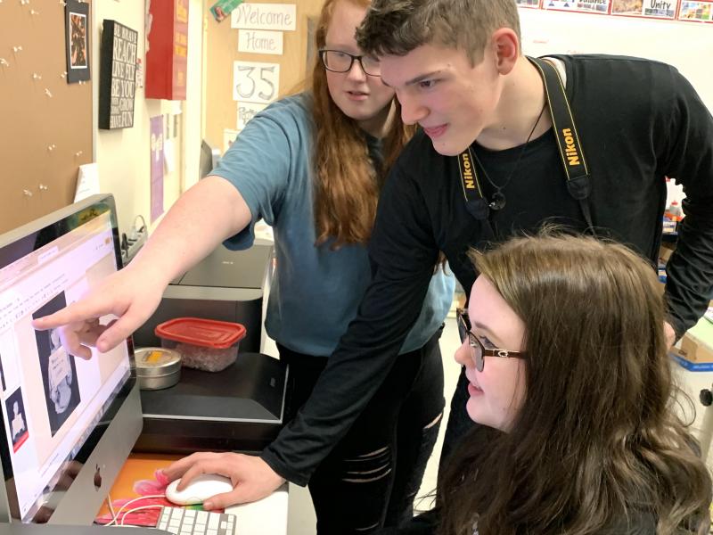 Medomak Valley sophomore Jame Rose and senior Emma Kavan share input with junior Madison Clarke work on the #WhyYouMatter campaign. (Courtesy Brooke Holland)