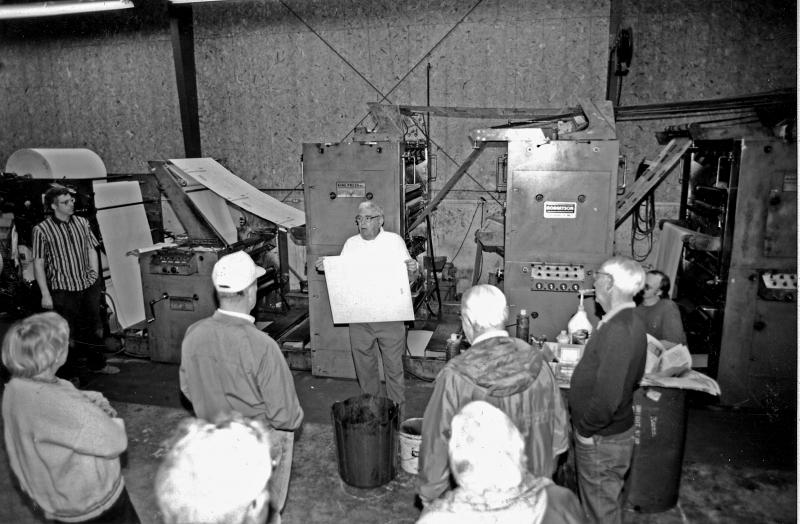 During an open house at Lincoln County News in 1996, Chris Roberts, left, and Samuel Roberts talk about the King newspaper press. Courtesy of LCN